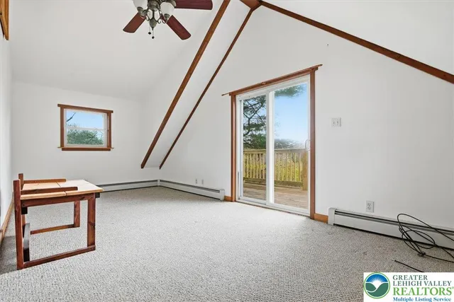 a view of a ceiling fan and window