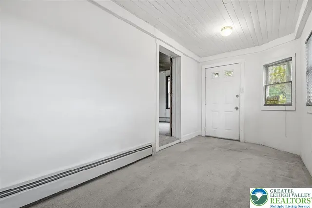 a view of an empty room with windows