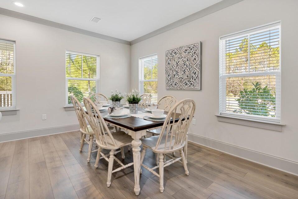 56 Golden Bell Ct Inlet Beach, Unit A Inlet Beach, FL 32461 - Photo 9 of 27 a view of a dining room with furniture and wooden floor
