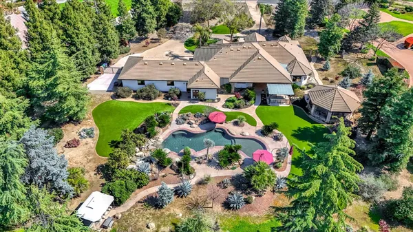a front view of a house with a yard and tree s