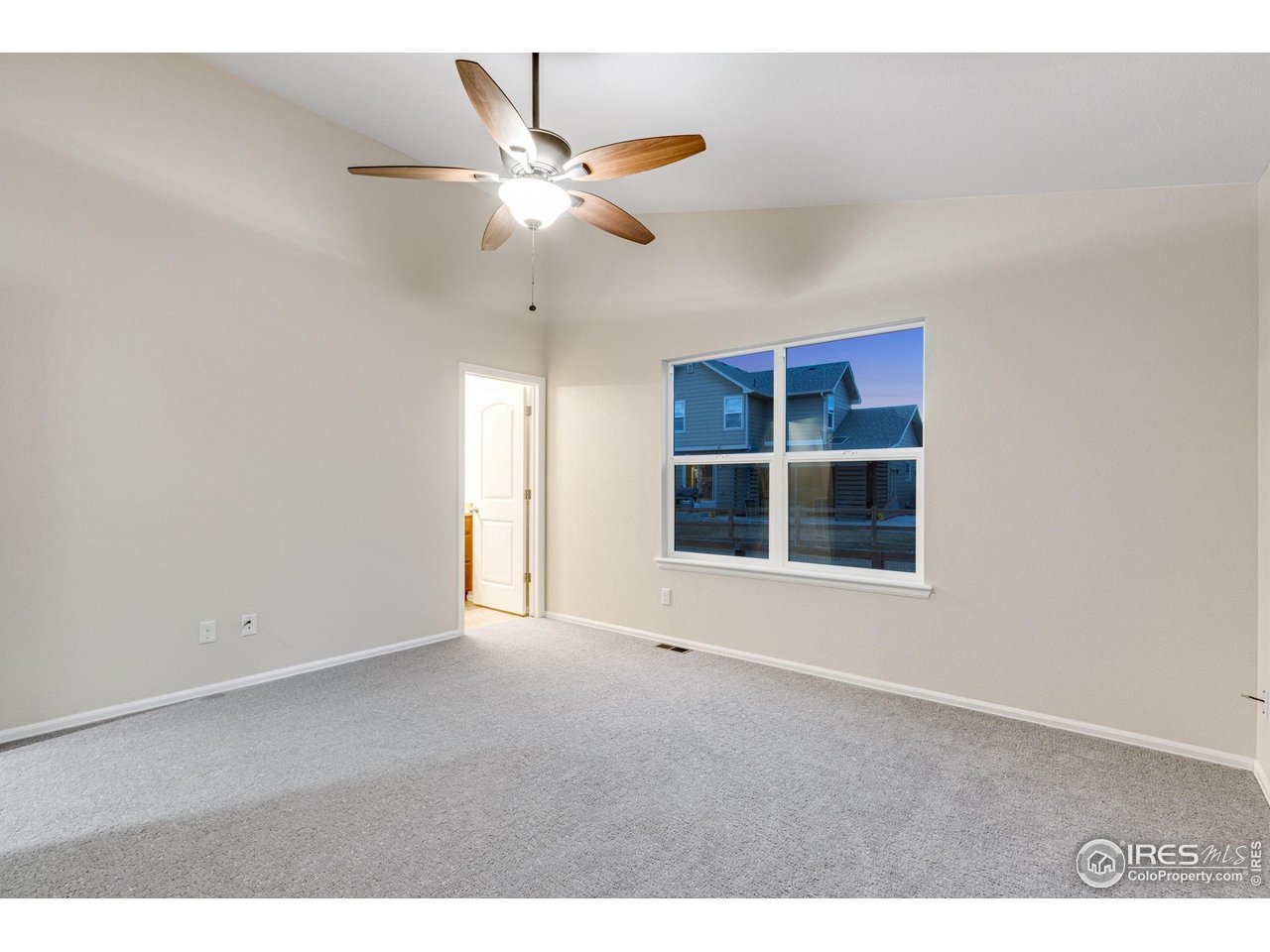 1554 Benfleet Court Windsor, CO 80550 - Photo 16 of 26 Main Floor Primary Bedroom with Walk-In Closet