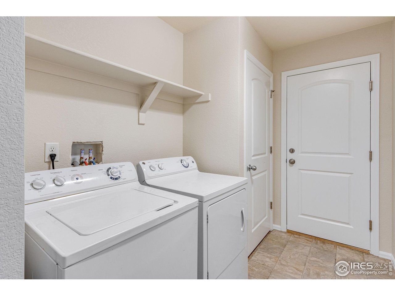 1554 Benfleet Court Windsor, CO 80550 - Photo 20 of 26 Convenient Main Floor Laundry Room