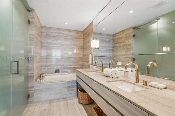 a bathroom with a granite countertop sink a large mirror and shower
