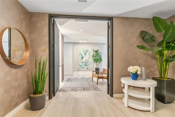 a living room with furniture and a potted plant