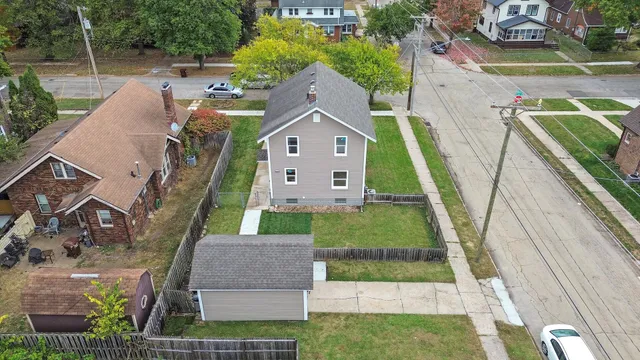 an aerial view of a house with a yard