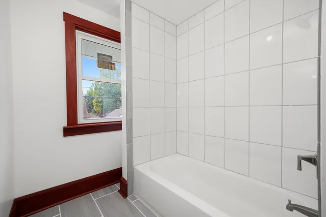 a bathroom with a bathtub and shower