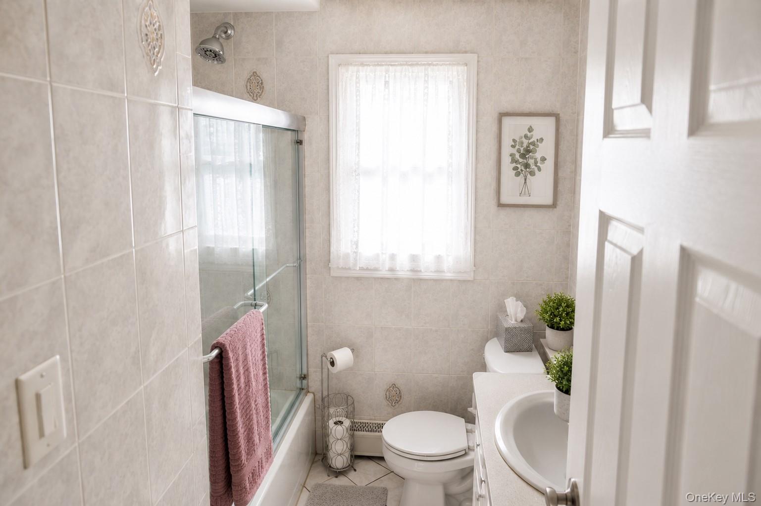 20 Carol Road Bethpage, NY 11714 - Photo 14 of 19 a white toilet sitting next to a bathroom sink