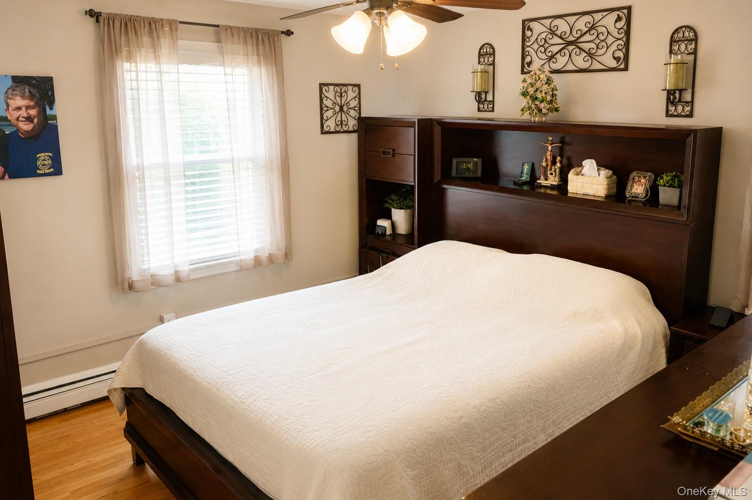 20 Carol Road Bethpage, NY 11714 - Photo 7 of 19 a large bed sitting in a bedroom next to a window