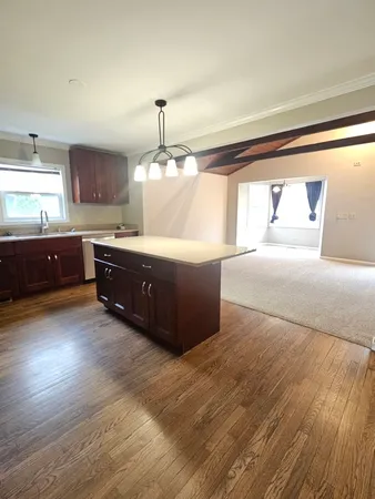 a living room with hard wood floors and a fireplace