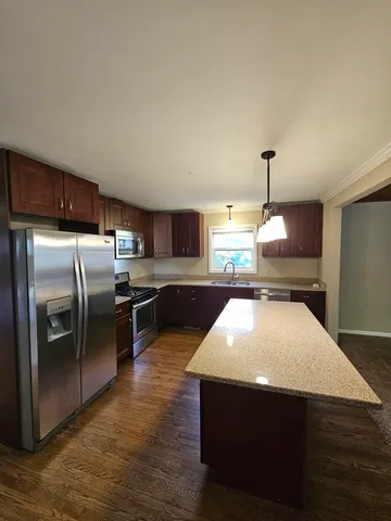 a kitchen with stainless steel appliances a refrigerator and a sink