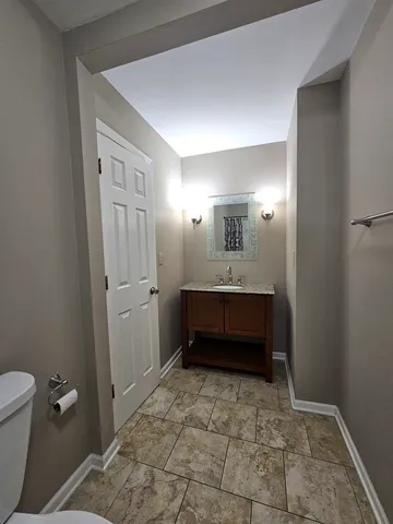 a bathroom with a sink a toilet and a mirror