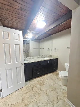 a bathroom with a toilet and a shower