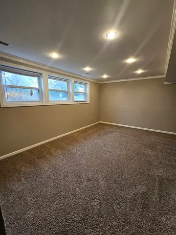 a view of an empty room and a window