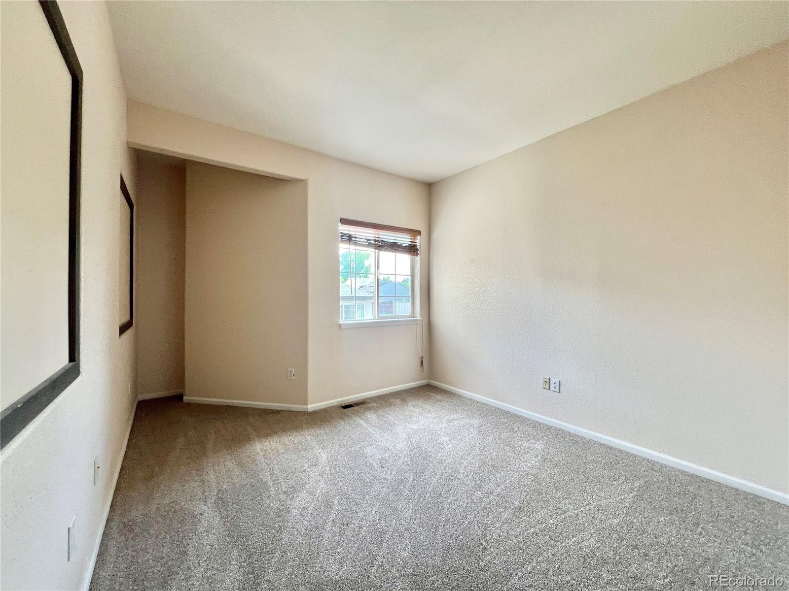 1385 South Chambers Road, Unit 102 Aurora, CO 80017 - Photo 8 of 20 an empty room with windows