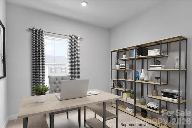 a view of a workspace with furniture and a bookshelf
