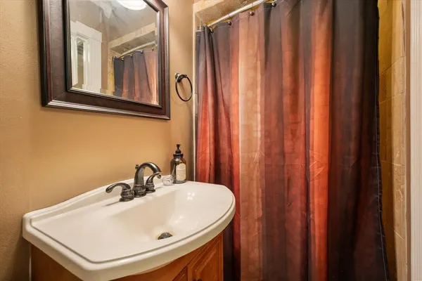 a bathroom with a sink a mirror and a window