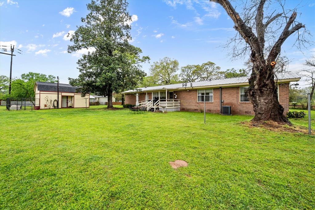 14036 Old Texaco Road Conroe, TX 77302 - Photo 18 of 40 a view of a house with a yard porch and sitting area