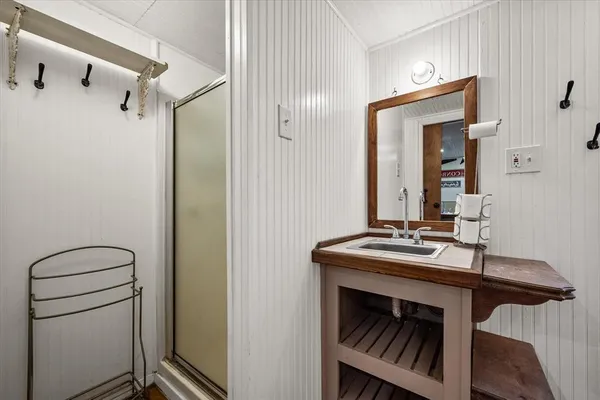 a bathroom with a sink a toilet and a mirror