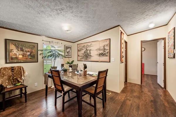 a dining room with furniture and window
