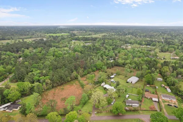 a view of a city with lush green forest
