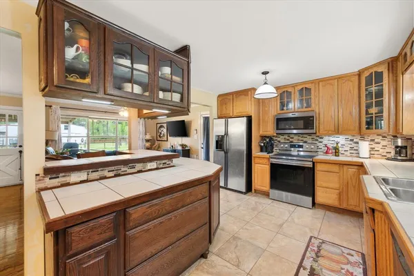 a kitchen with stainless steel appliances a stove microwave and refrigerator
