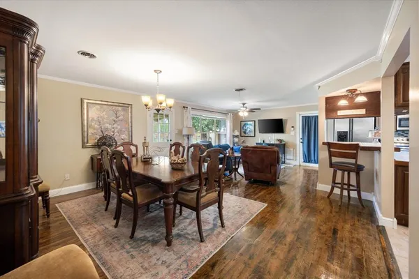 a view of a dining room with furniture window and wooden floor