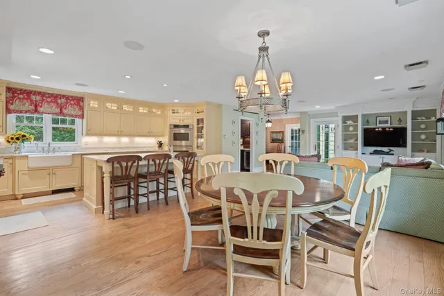 a view of a dining room with furniture wooden floor and chandelier
