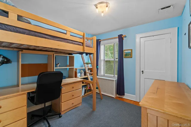 a bedroom with a bed and a chair