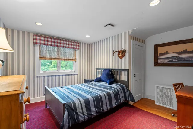 a bedroom with a bed and a window