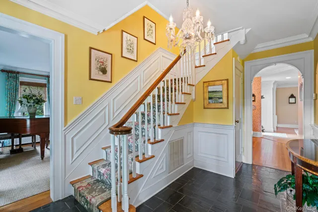 a view of an entryway with wooden floor and stairs
