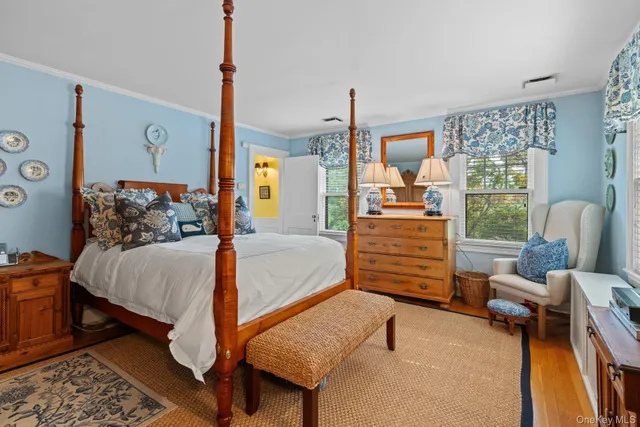 a bedroom with furniture and wooden floor