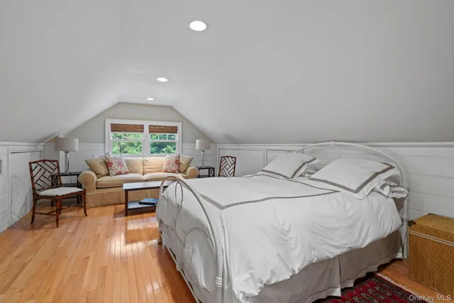 a bed room with a bed and a chair