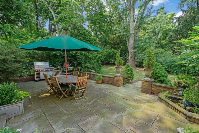 a view of backyard with outdoor seating and trees