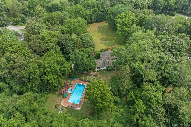 an aerial view of a house with a yard and outdoor seating