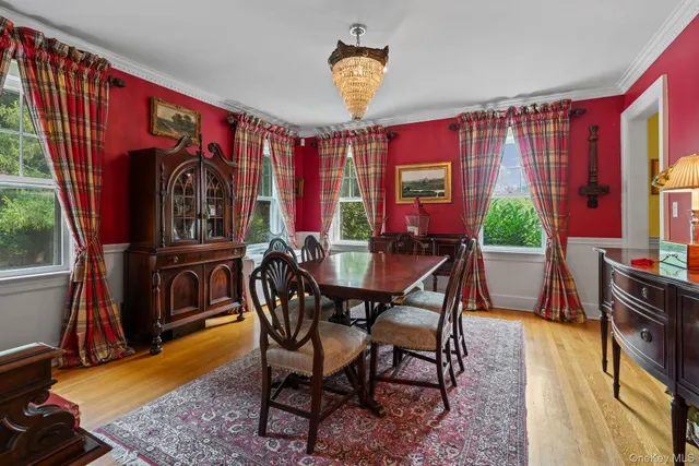 a view of a dining room with furniture and chandelier