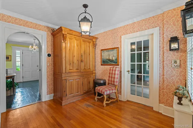 a view of a livingroom with wooden floor and furniture