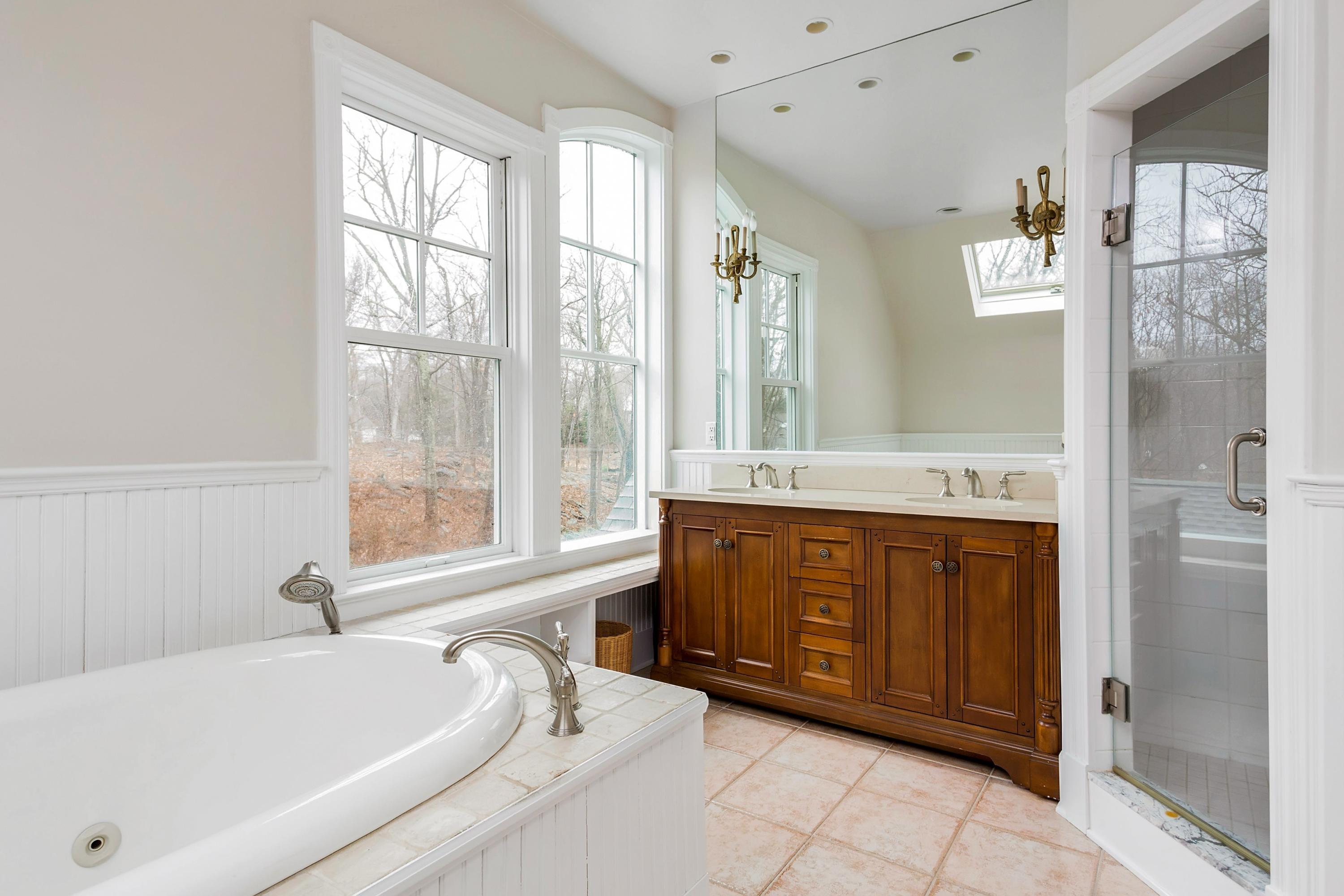 6 Wildcat Road Darien, CT 06820 - Photo 13 of 27 a bathroom with a tub sink and shower