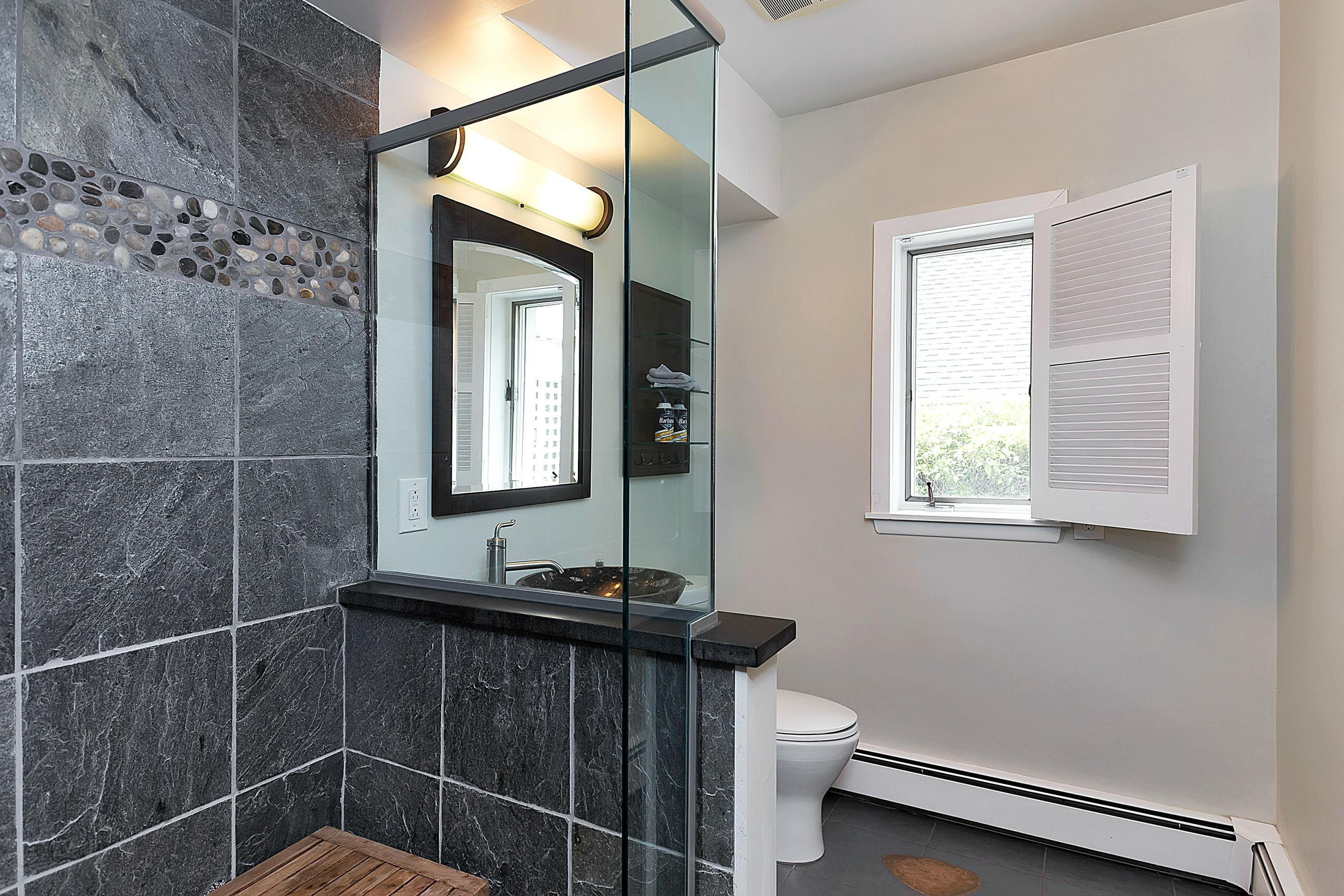 6 Wildcat Road Darien, CT 06820 - Photo 23 of 27 a bathroom with a toilet a sink and mirror