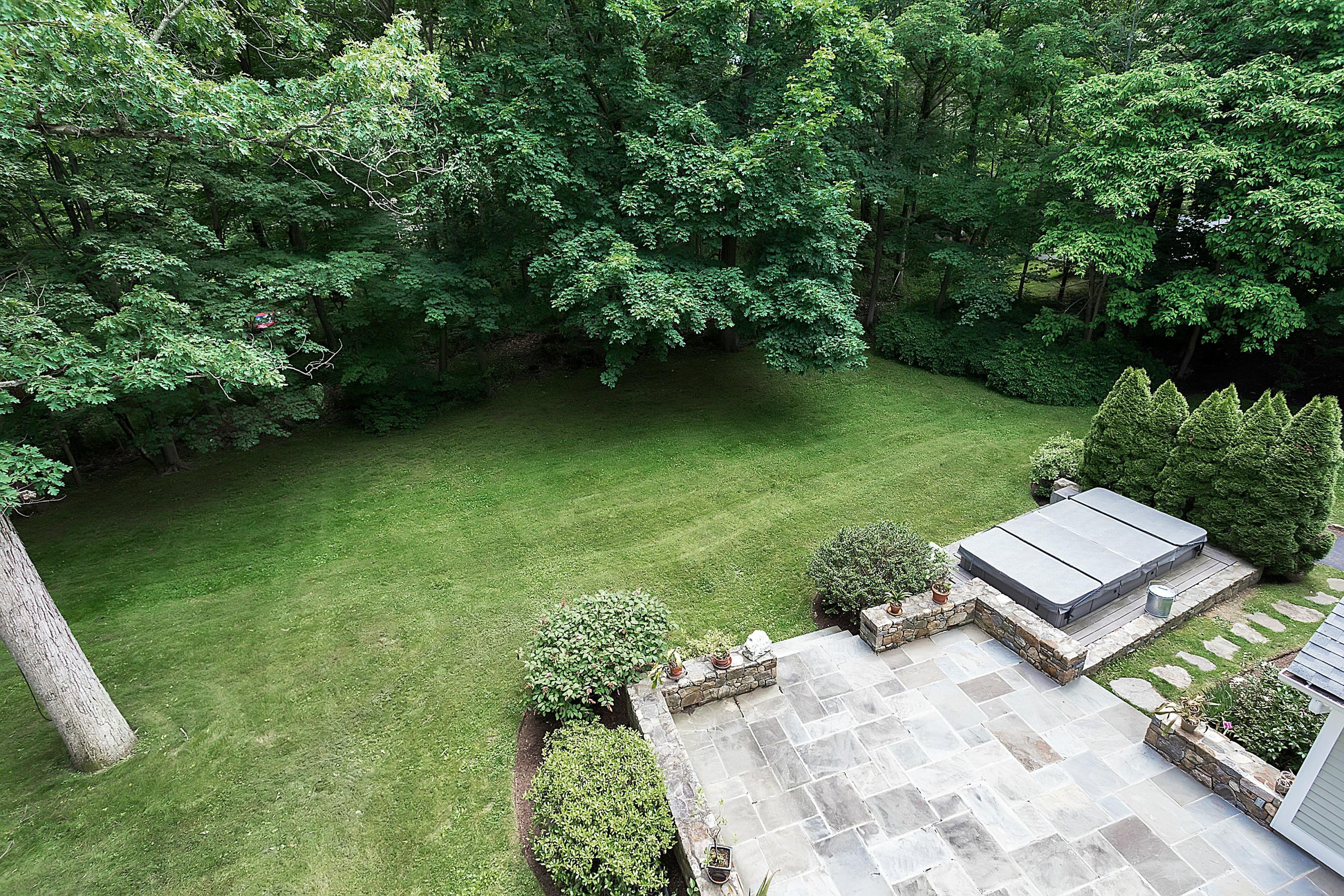 6 Wildcat Road Darien, CT 06820 - Photo 25 of 27 a view of a garden with a bench