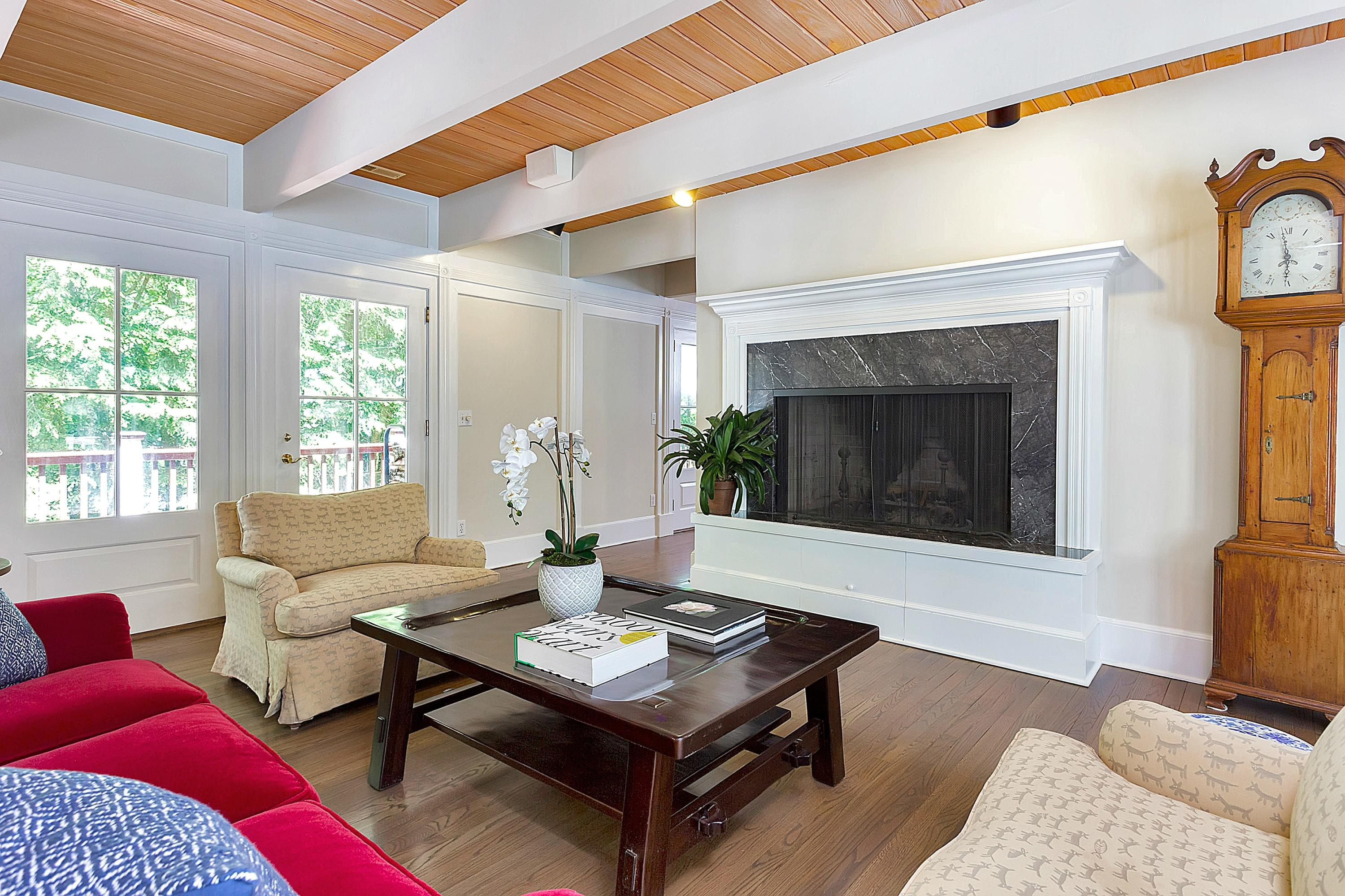 6 Wildcat Road Darien, CT 06820 - Photo 5 of 27 a living room with furniture a rug and a fireplace