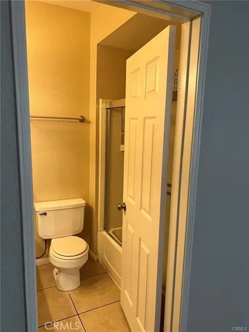 a white toilet sitting next to a small yard