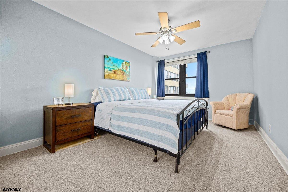 101 South Raleigh Avenue, Unit 619 Atlantic City, NJ 08401 - Photo 13 of 24 a bedroom with a bed and a chandelier