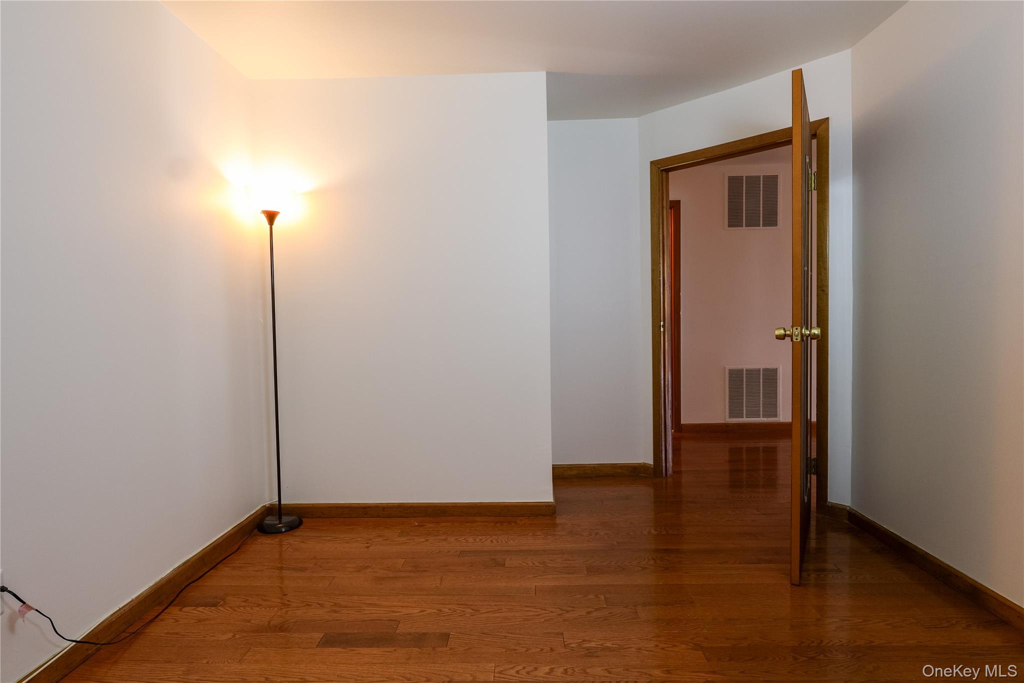 1306 Rosewood Court Highland Mills, NY 10930 - Photo 16 of 44 a view of an empty room with wooden floor and a window