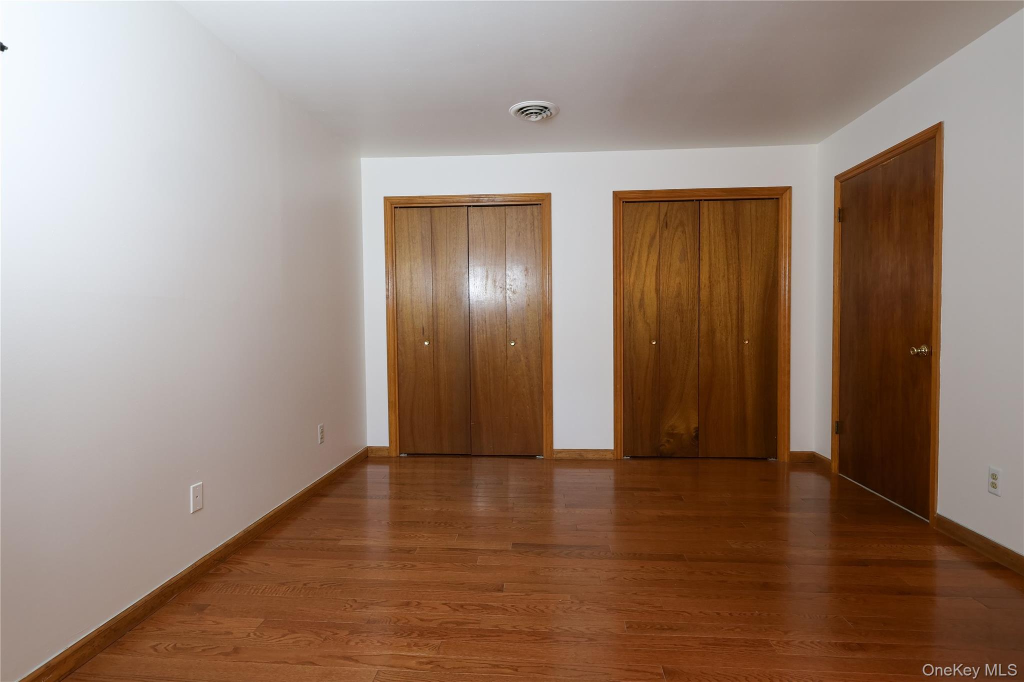 1306 Rosewood Court Highland Mills, NY 10930 - Photo 18 of 44 a view of an empty room with wooden floor and closet