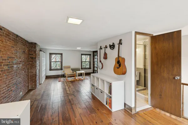 a living room with furniture and a book shelf