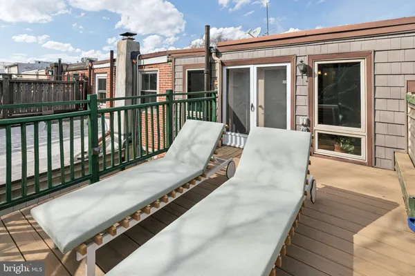 a view of balcony with wooden floor and outdoor seating