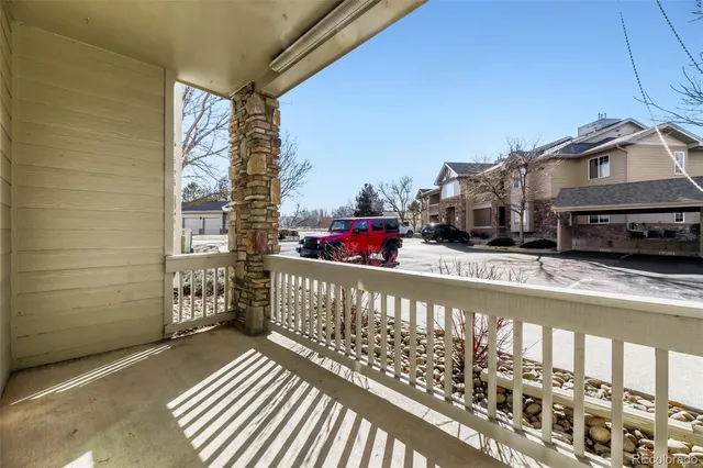 a view of a balcony with cars