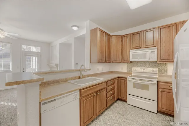 a kitchen with a sink stove and cabinets