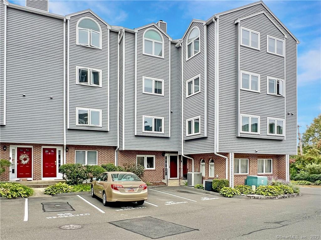 7 Seir Hill Road, Unit 13 Norwalk, CT 06850 - Photo 1 of 1 a front view of a residential apartment building with a yard