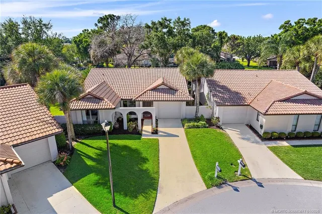 an aerial view of a house with swimming pool garden and patio